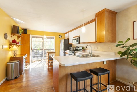 A kitchen with wooden cabinets and a white countertop.