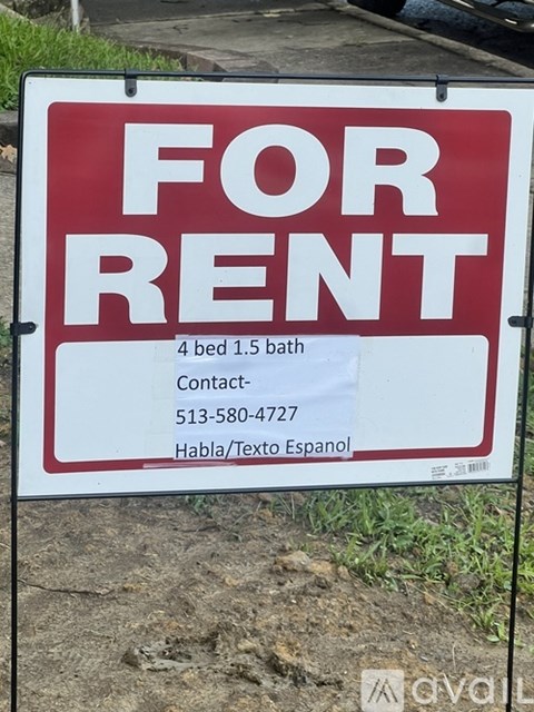 A red and white For Rent sign is displayed outdoors.