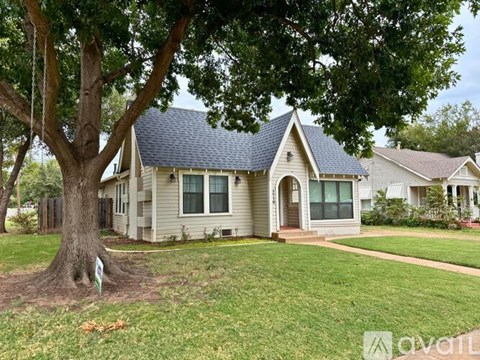 A house with a tree in front of it.