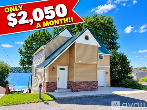 A house with a sign that says "ONLY $2,050 A MONTH!!!" in front of it.