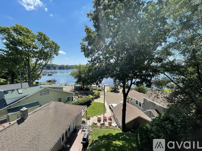 A view from a balcony overlooking a lake and houses.