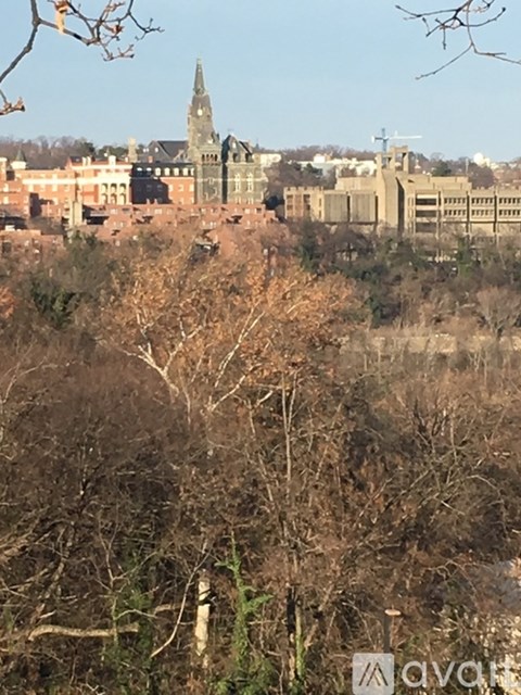 A view of a cityscape with buildings and trees in the foreground.