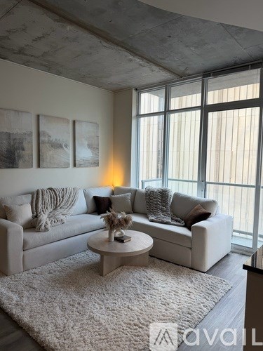 A living room with a white couch and a round table in front of it.