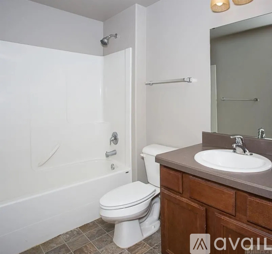 A bathroom with a toilet, sink, and bathtub.