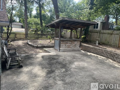 A backyard with a gazebo and a fireplace.