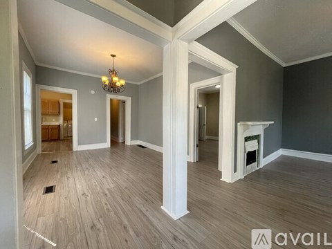A room with a fireplace and a chandelier.