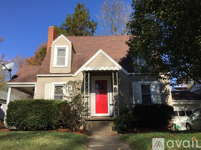 A house with a red door is for sale.