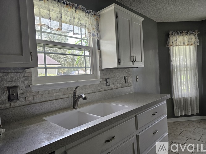 A kitchen with a sink and cabinets.