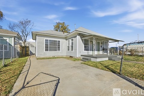 A house with a grey roof and a white front porch is available for rent.