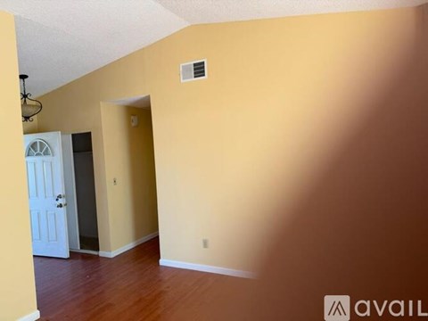 A room with a white door and a wall-mounted light fixture.
