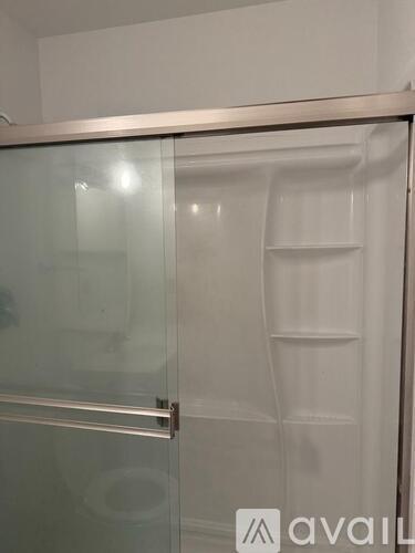 A glass door with a handle and a metal frame.