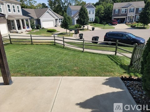 A suburban neighborhood with a car parked in the driveway.