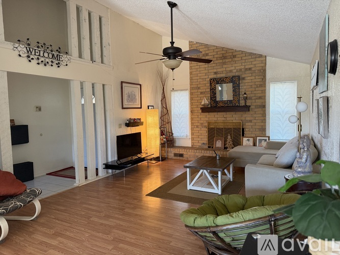 A living room with a fireplace and a television.