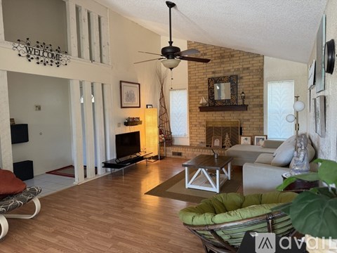 A living room with a fireplace and a television.