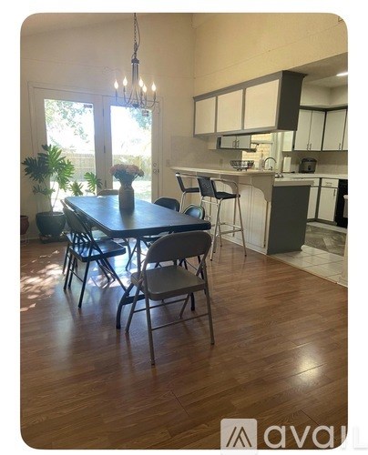 A dining room with a table and chairs.