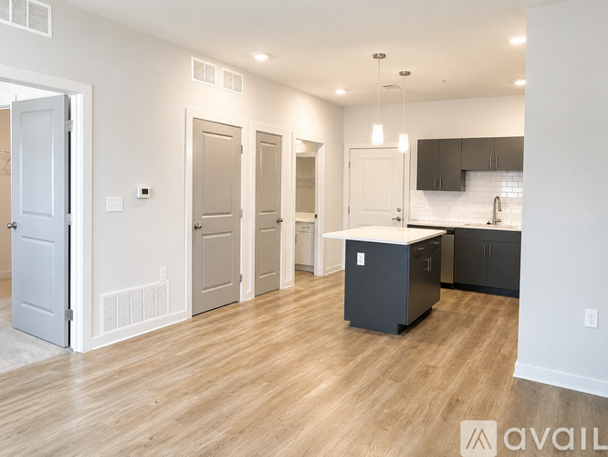 A kitchen area with a white cabinet and a black fridge.