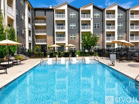 A large swimming pool in front of apartment buildings.