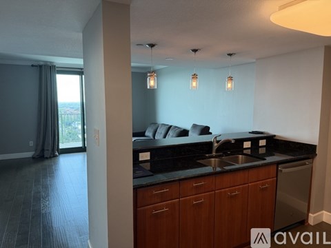 A kitchen with wooden cabinets and a black countertop.
