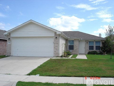 A house with a garage and a driveway in front.