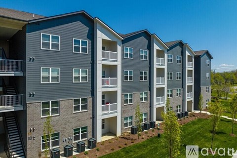 A row of modern apartment buildings with balconies and a clear blue sky.