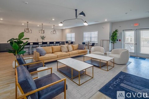 A living room with a sofa, chairs, and a coffee table.