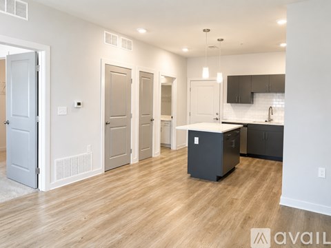 A kitchen area with a white cabinet and a black fridge.