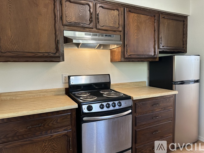 A kitchen with a stove, oven, and cabinets.