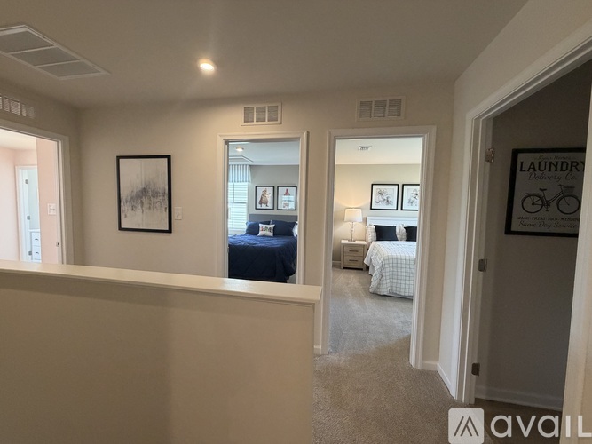 A bedroom with a bed and a painting on the wall.