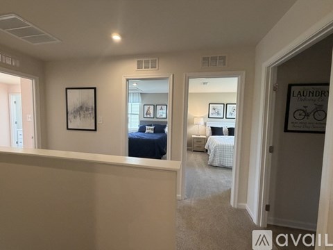 A bedroom with a bed and a painting on the wall.