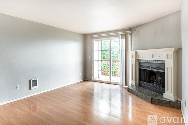 A spacious living room with a fireplace and sliding glass doors.