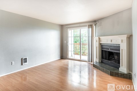 A spacious living room with a fireplace and sliding glass doors.