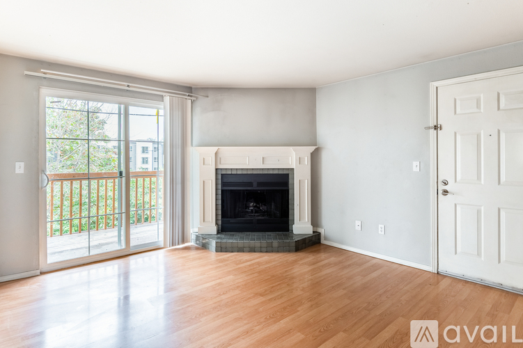 A living room with a fireplace and sliding glass doors.
