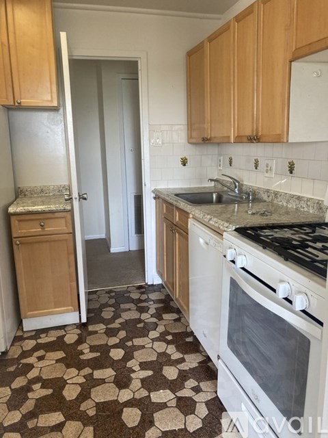 A kitchen with a checkered floor and a white oven.