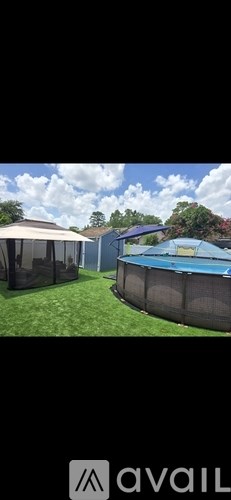 A backyard with a pool and a fence.