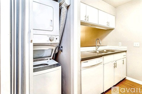 A white fridge and white cabinets in a kitchen.