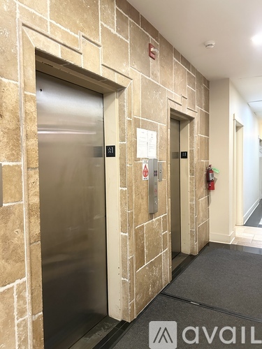 A hallway with two elevators, one of which is numbered 21.