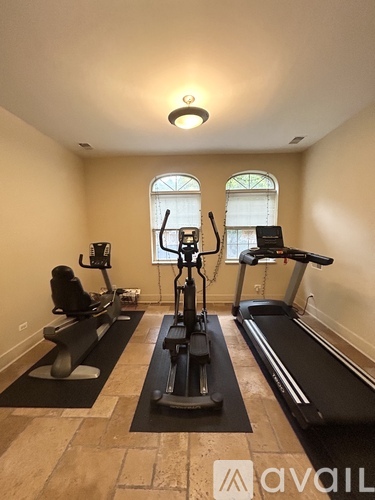 A home gym with treadmills, elliptical machines, and a stationary bike.