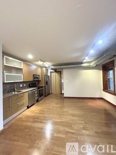 A kitchen with wooden floors and a countertop with a microwave and oven.