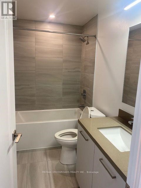 A bathroom with a toilet, sink, and shower.