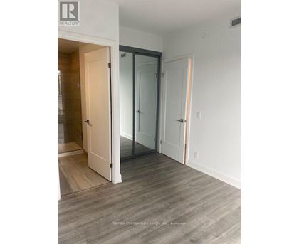 A room with a white door and a glass door.