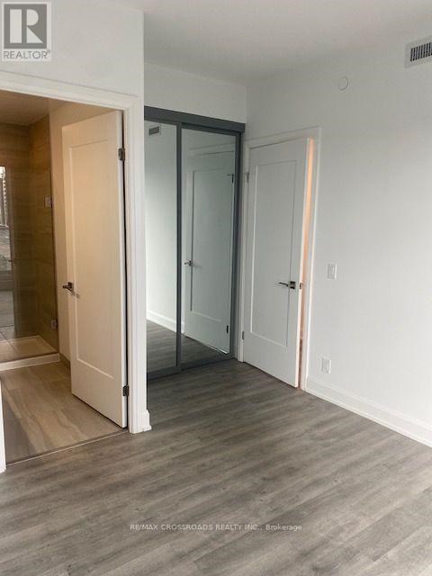 A room with a white door and a glass door.