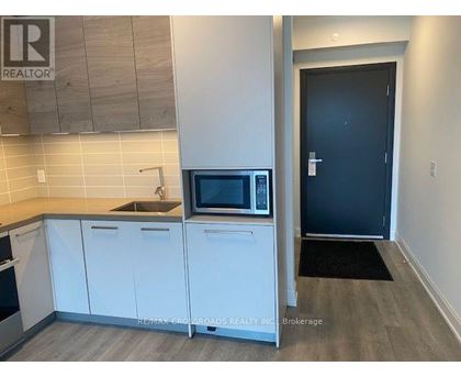 A kitchen with a microwave and a sink.