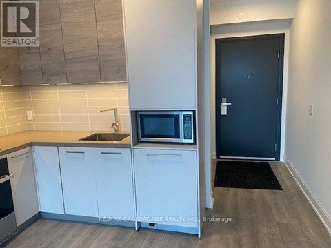 A kitchen with a microwave and a sink.