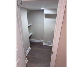 A hallway with a white door and a grey wall.