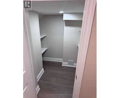 A hallway with a white door and a grey wall.