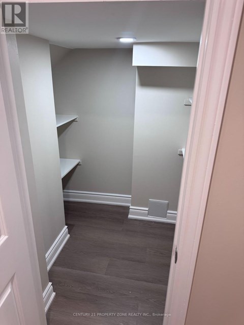 A hallway with a white door and a grey wall.