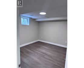 A room with light grey walls and wooden flooring.