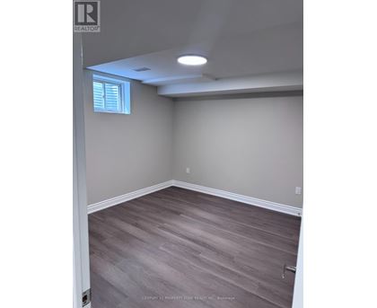 A room with light grey walls and wooden flooring.