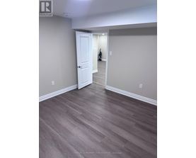 A room with a white door and grey walls.