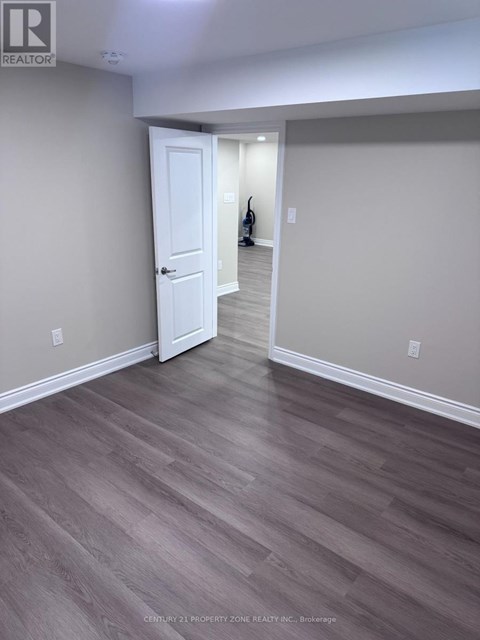 A room with a white door and grey walls.